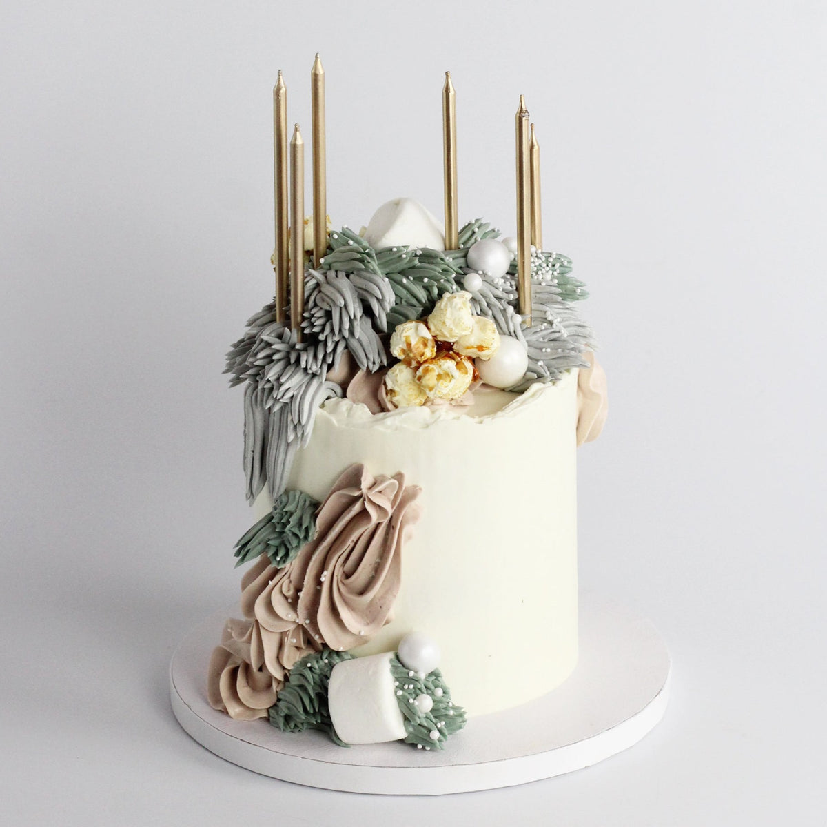 Our signature Shag Cake in soft tones, covered in shaggy buttercream!