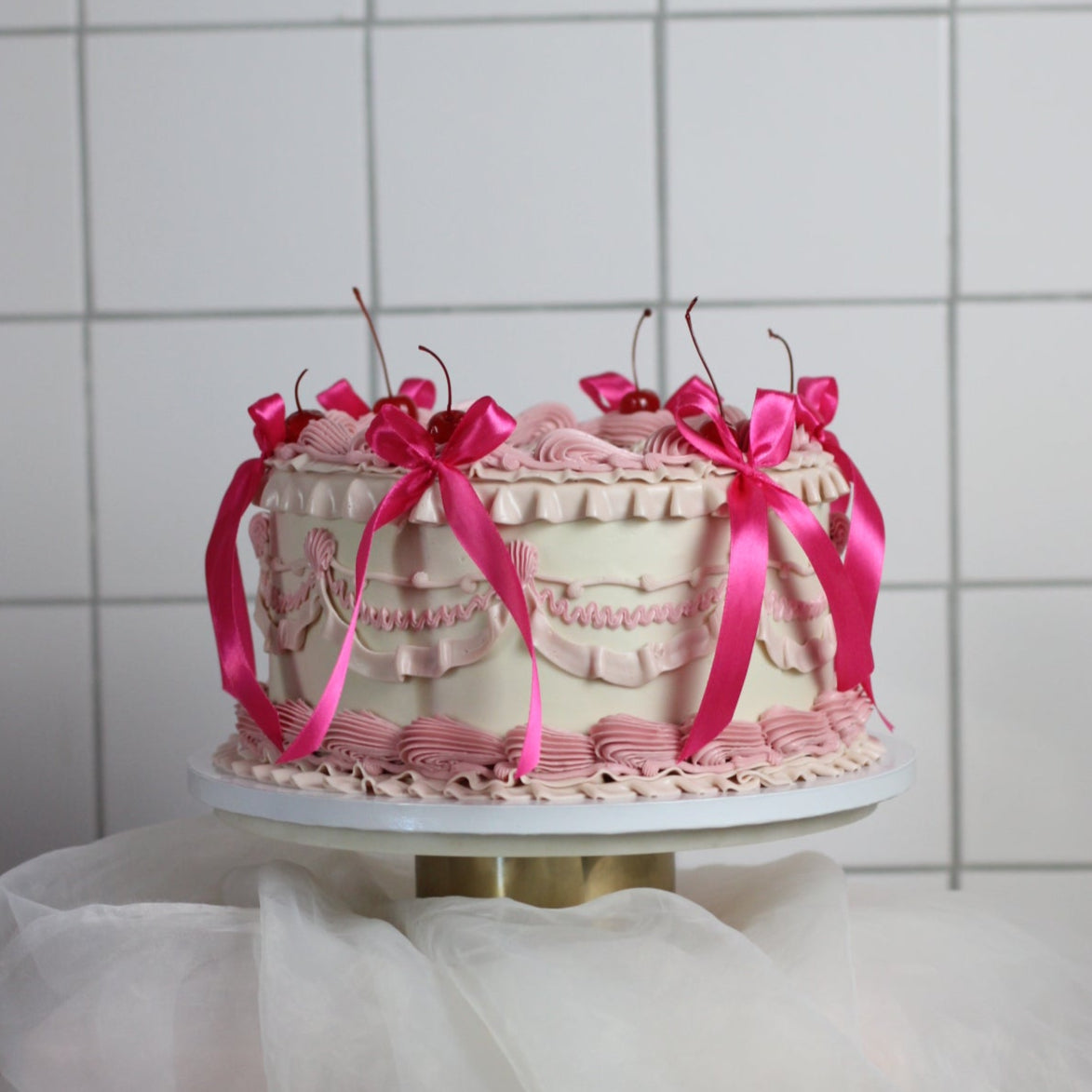 Vintage cake with white base, rose frills and hot pink silk bows! 