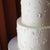 Close-up of the hand-painted white buttercream florals - a classic yet modern all white wedding cake