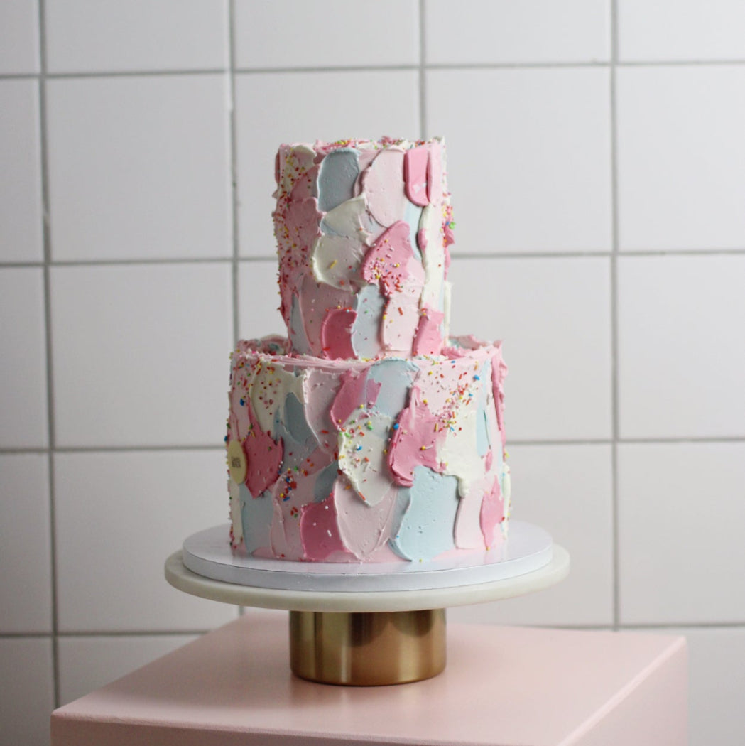 Fun birthday cake with 2 tiers, Swiss meringue buttercream textured surface and colorful sprinkles all over!
