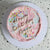 Our signature Birthday Cloud Cake with blue & pink fluffy icing and a dash of sprinkles, with handwritting message on the cake