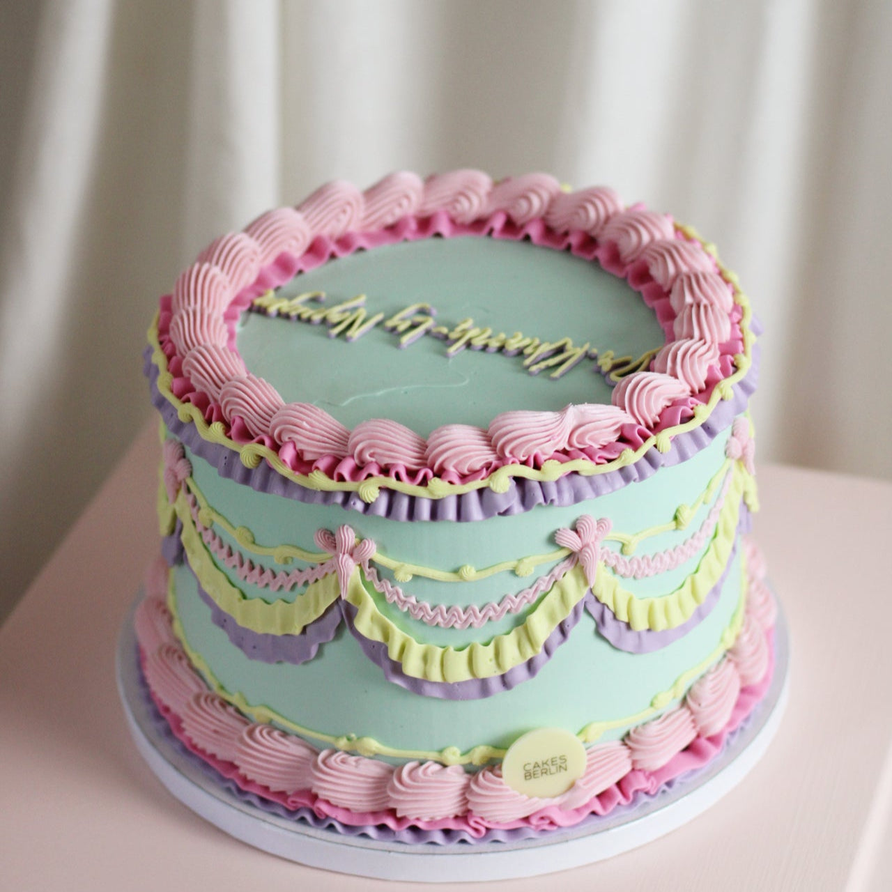 Vintage style cake, decorated with pastel  handmade mixed frills. Designed and baked in our Kreuzberg studio, delivered in berlin