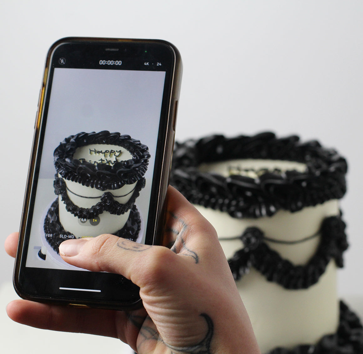 Vintage cake with black frills on a white base