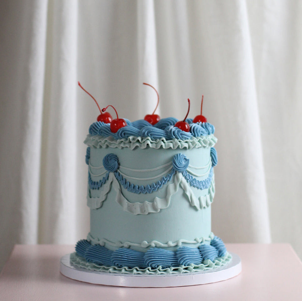 Blue PAAARTY - vintage style frill cake adorned with red cherries on top!