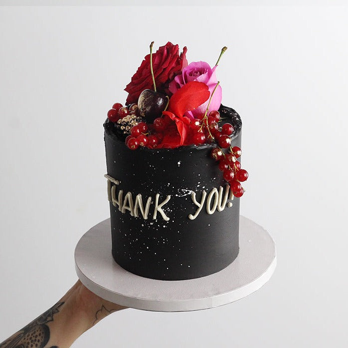 BOLD BEAUTY cake: decorated with bold poppy florals and fresh fruits, on a black cake base