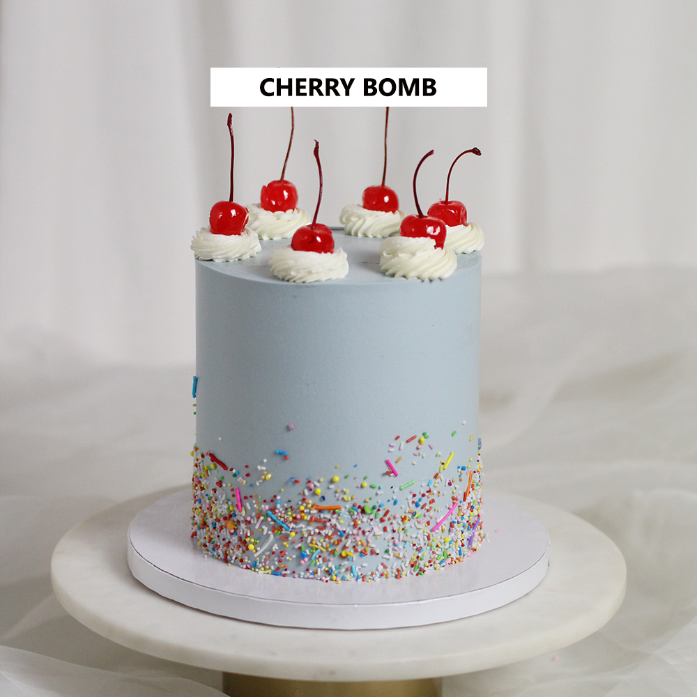 CHERRY BOMB - Every child´s dream cake! Light blue icing, sprinkles and delicious cherries on top!