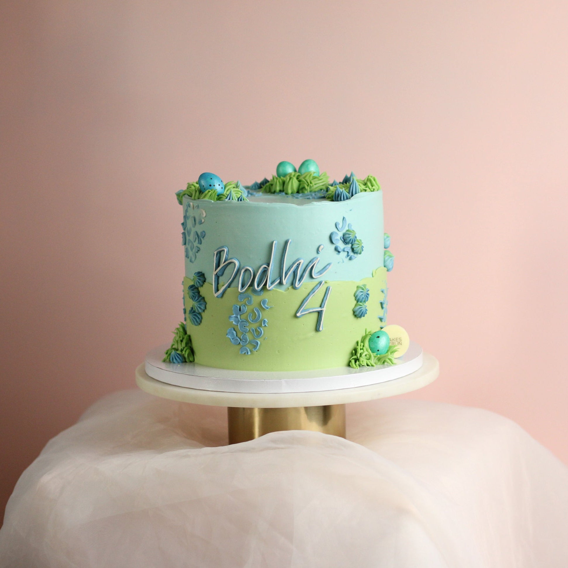 Dino cake in pastel blue and green
