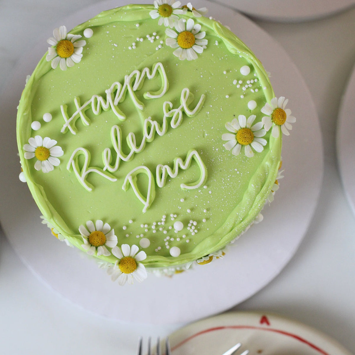Daisy Days cake in green with hand piped msg
