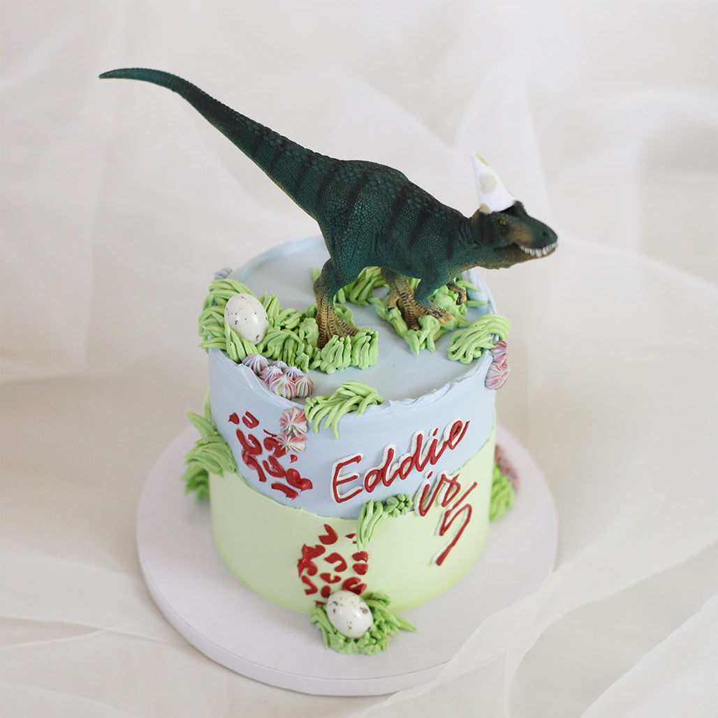 Dino cake in sky blue &amp; green with a touch of red.