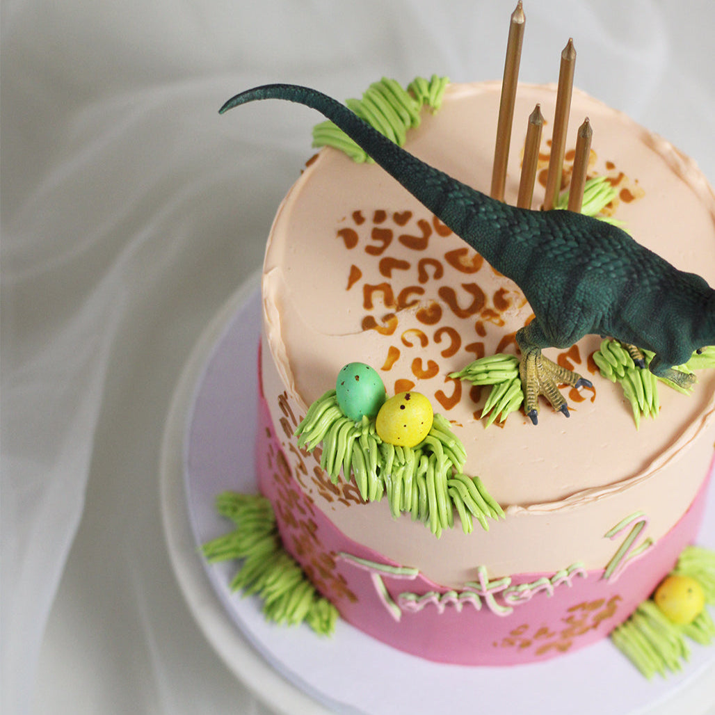 Details of the DINO cake design in a gorgeous mix of pink &amp; orange with hints of green.