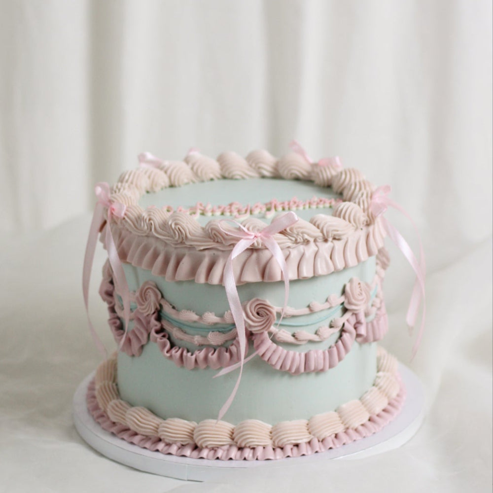 Vintage style frill cake in gorgeous pastel pink and sky blue frills, with silk bows. hand made in our kreuzberg studio - delivered in Berlin