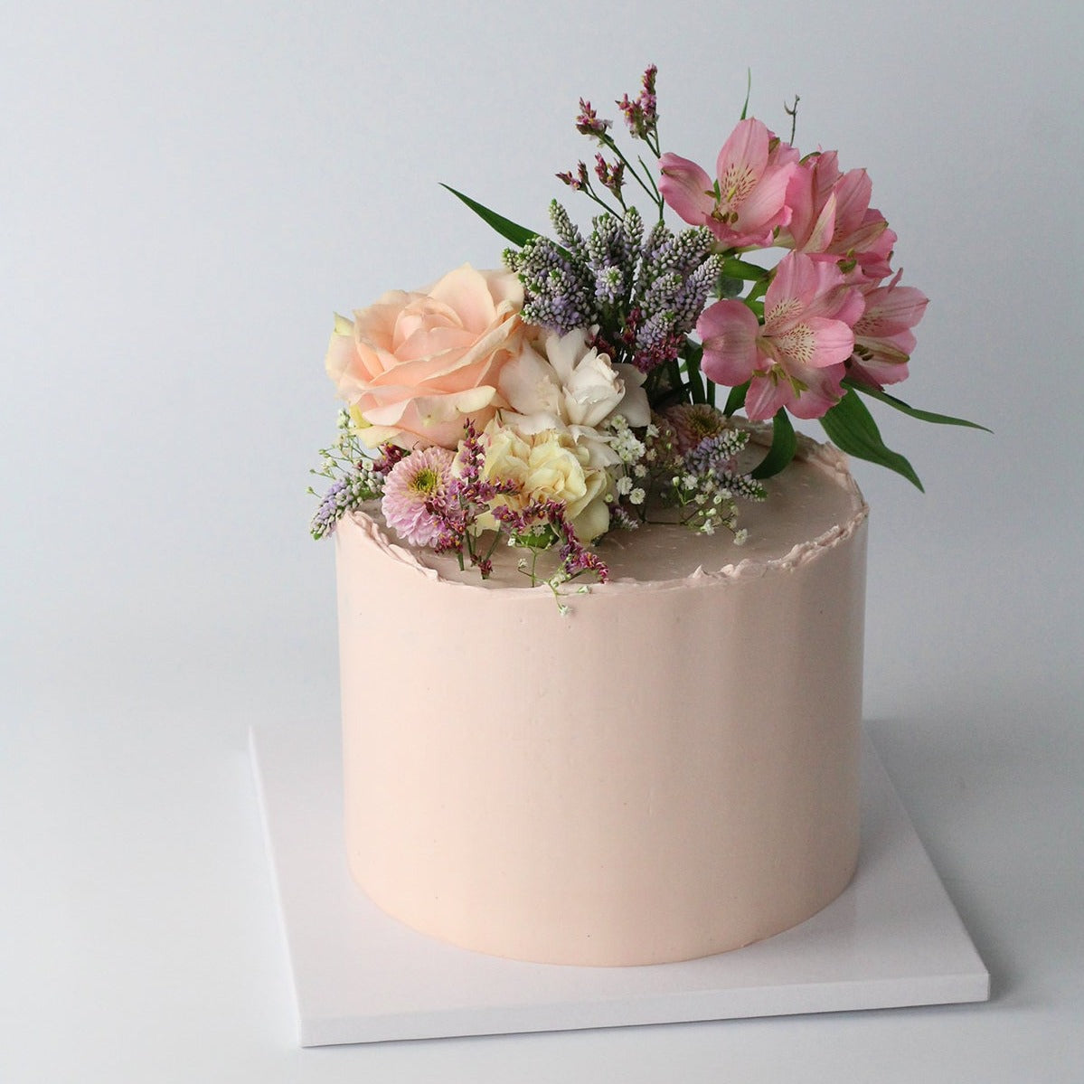 Floral Cutie Cake - Our signature cake with rosé base, adorned with fresh flowers! 
Made at our bakery in Kreuzberg - Delivered in Berlin