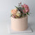 Floral Cutie Cake - Our signature cake with rosé icing adorned with fresh flowers!