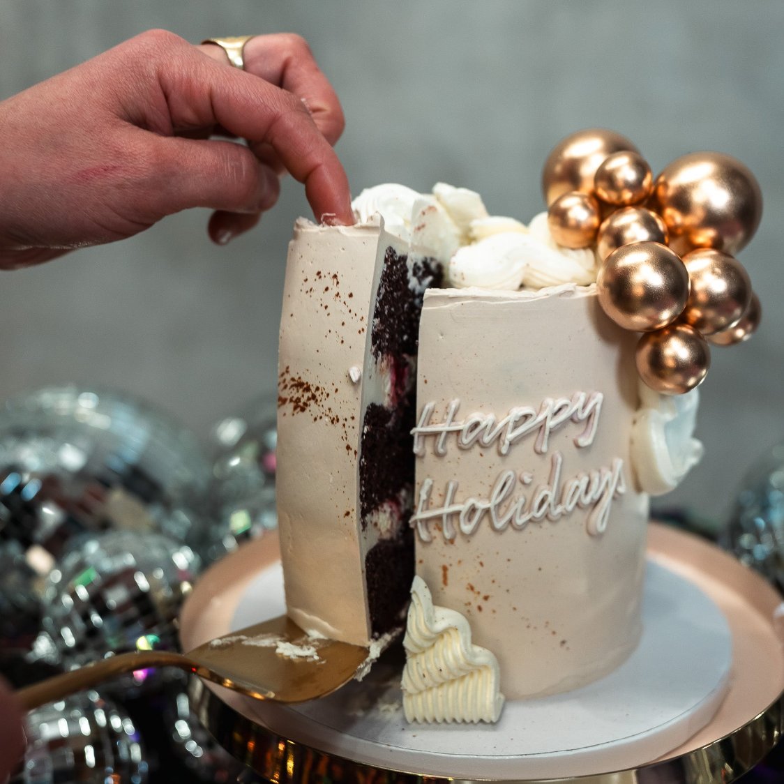 Add a touch of holiday magic to your celebration! This elegant cake features an off-white base with wavy buttercream frills, delicately adorned with golden ornaments (non-edible). A stunning centerpiece for Christmas, New Year’s, or any festive gathering.