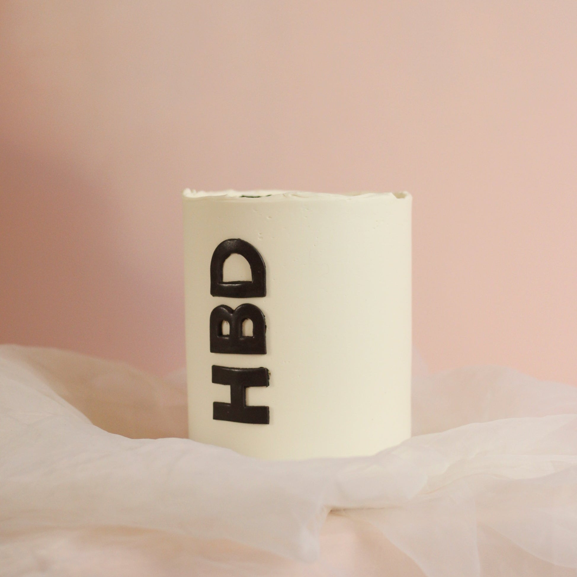 Custom-color smooth buttercream birthday cake with a simple but bold design, finished with black “HBD” fondant lettering. A modern, minimalist celebration cake.
