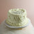 All-white heart-shaped cake with message on top