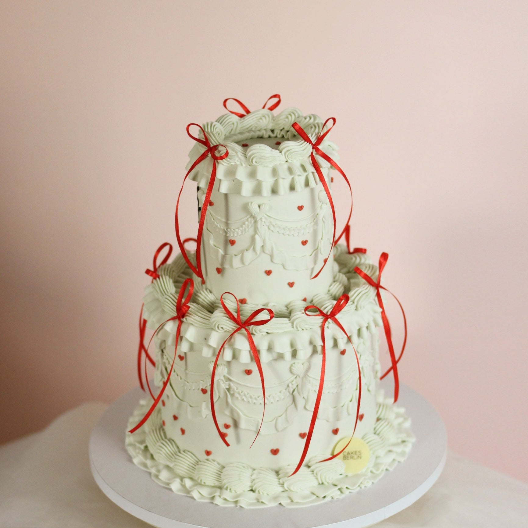 Two tier vintage cake with tiny red hearts and red silk bows - is she perfect, or what?!