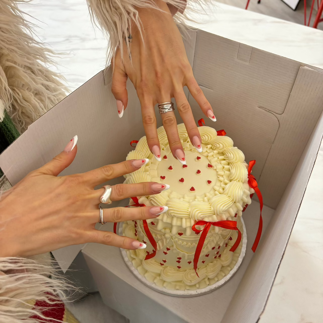 Vintage style white frill cake with little red hearts all over adorned with red silk bows. With Sarah´s MATCHING NAILS <3