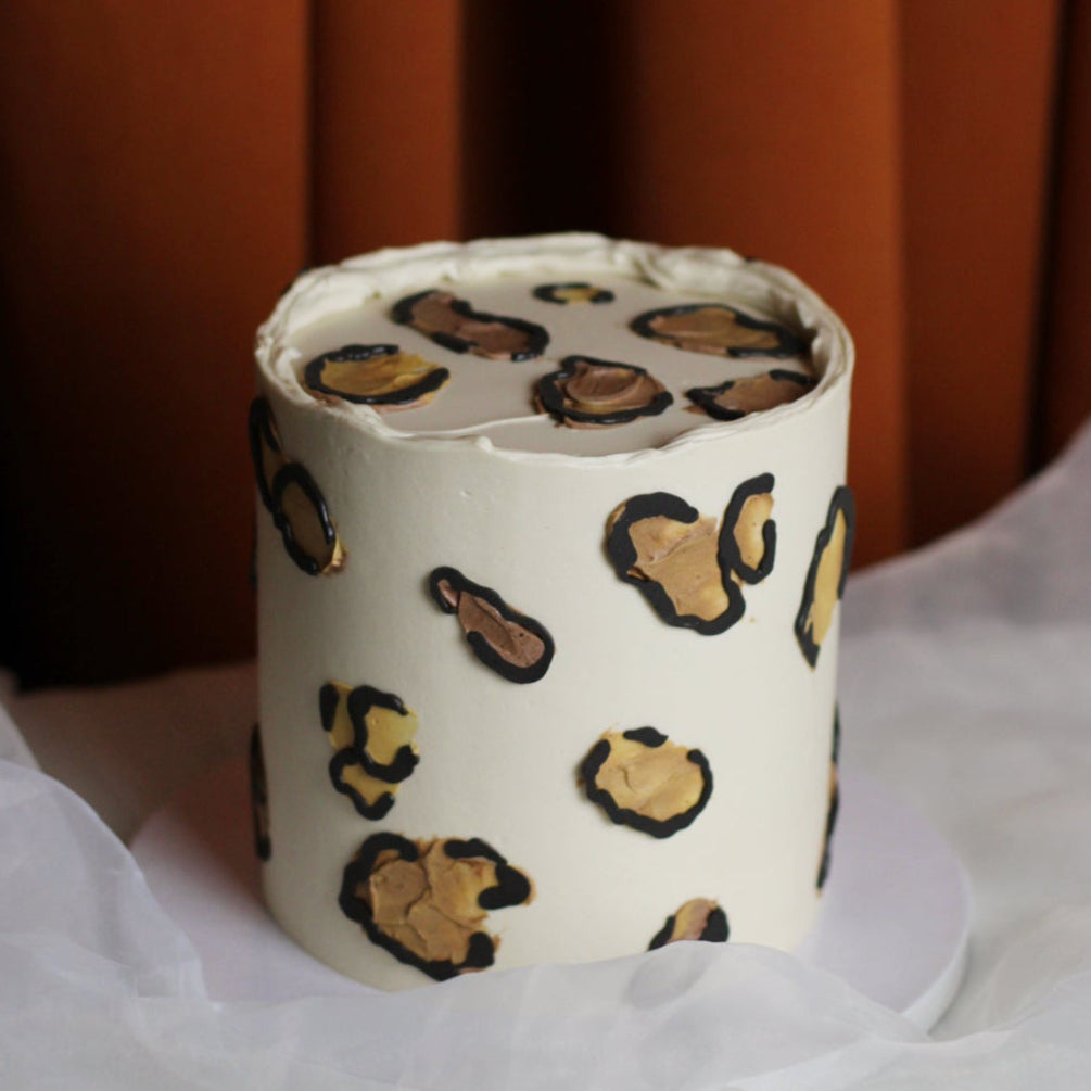 Beige cake decorated with natural toned leopard print buttercream