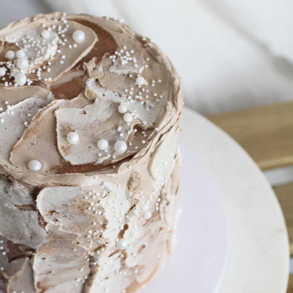 Our signature birthday Cloud Cake (natural tone) with earth-tone fluffy icing and a dash of sprinkles.