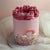 Dreamy rainbow cake decorated with colorful sprinkles and a piped rainbow, perfect for birthdays, parties, and celebrations.