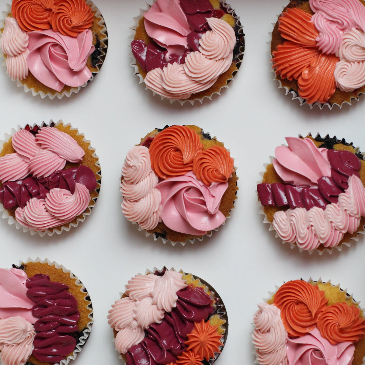 Mixed pinks &amp; orange cupcakes