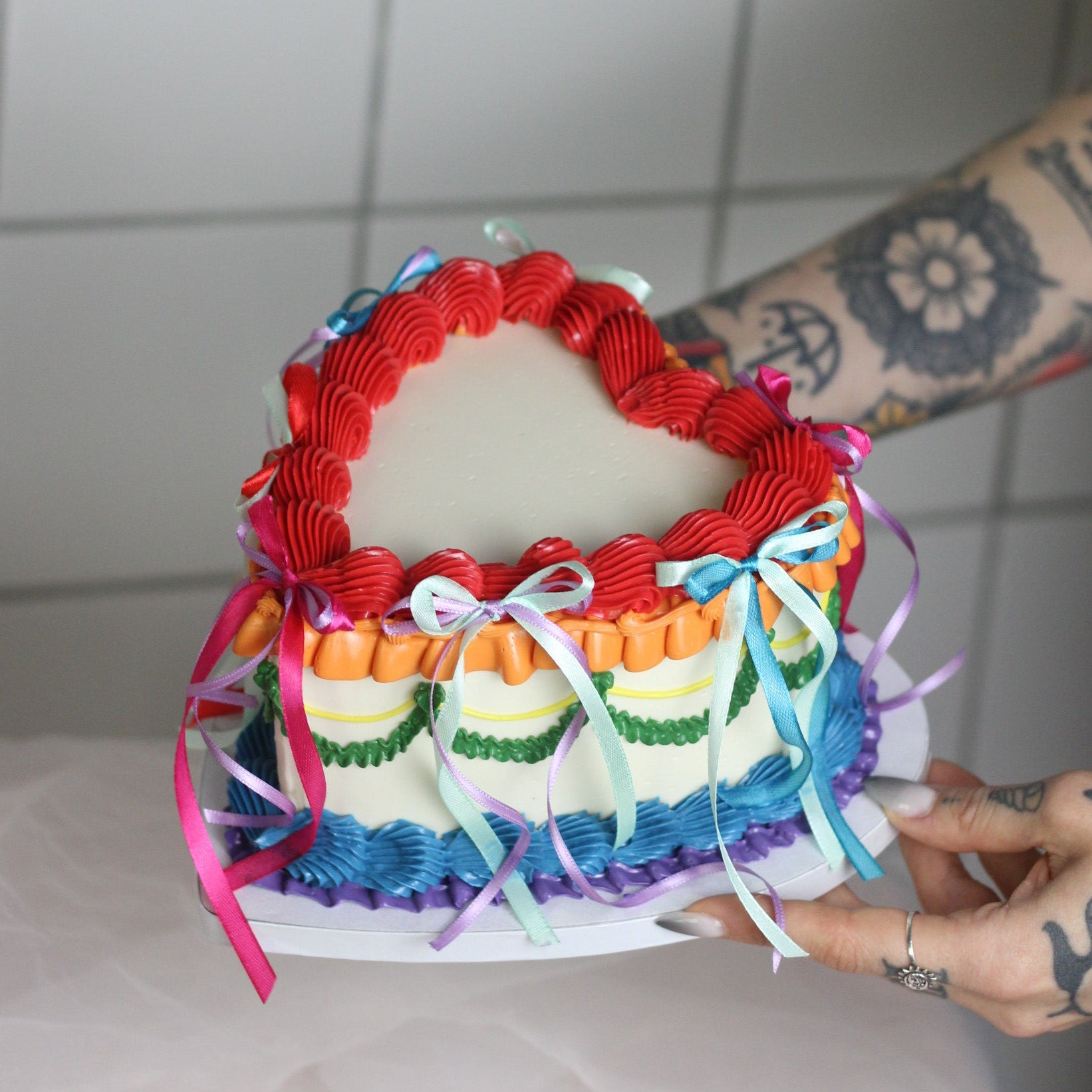 Heart-shaped Pride cake with rainbow vintage buttercream piping and optional colorful silk bow decoration. A joyful centerpiece for Pride Month, June celebrations, Berlin Pride events, birthdays, and colorful gatherings. 🌈🎀
