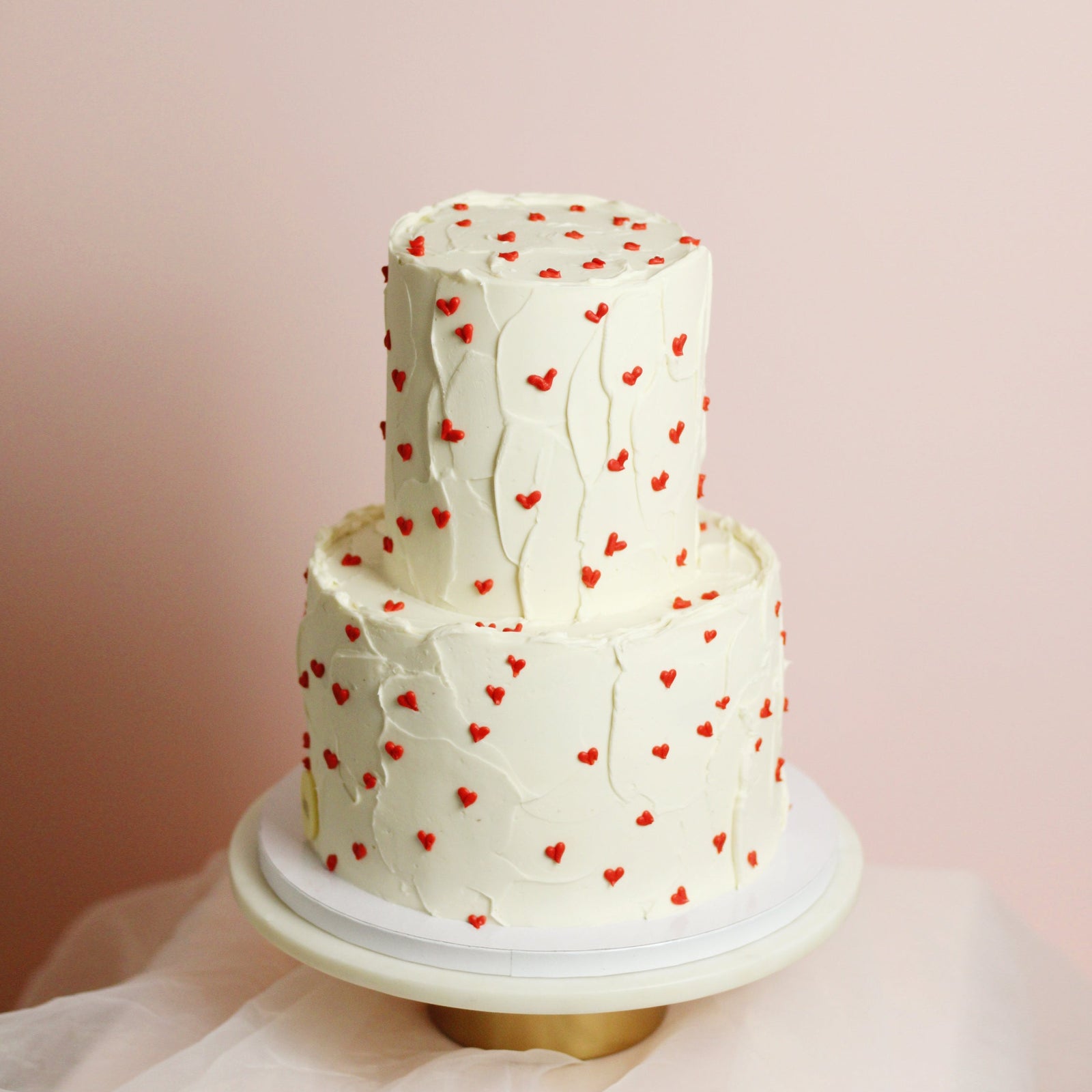 Our sweet vlentina! White tetured base and tiny buttercream red hearts all around. 