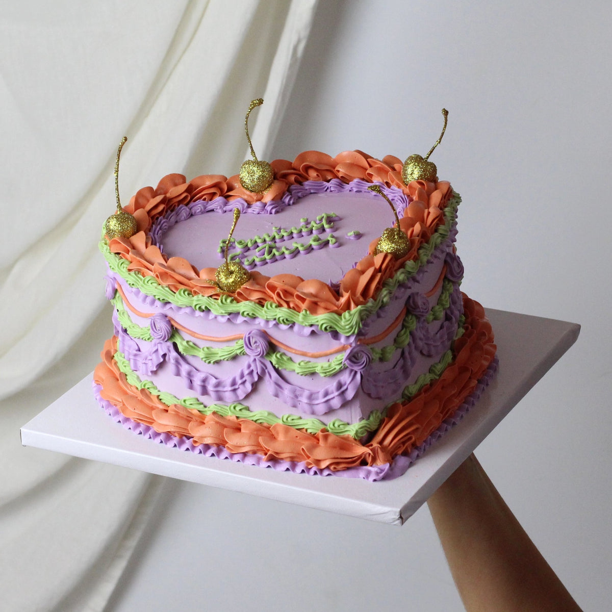 Purple and orange vintage cake with golden glitter cherries