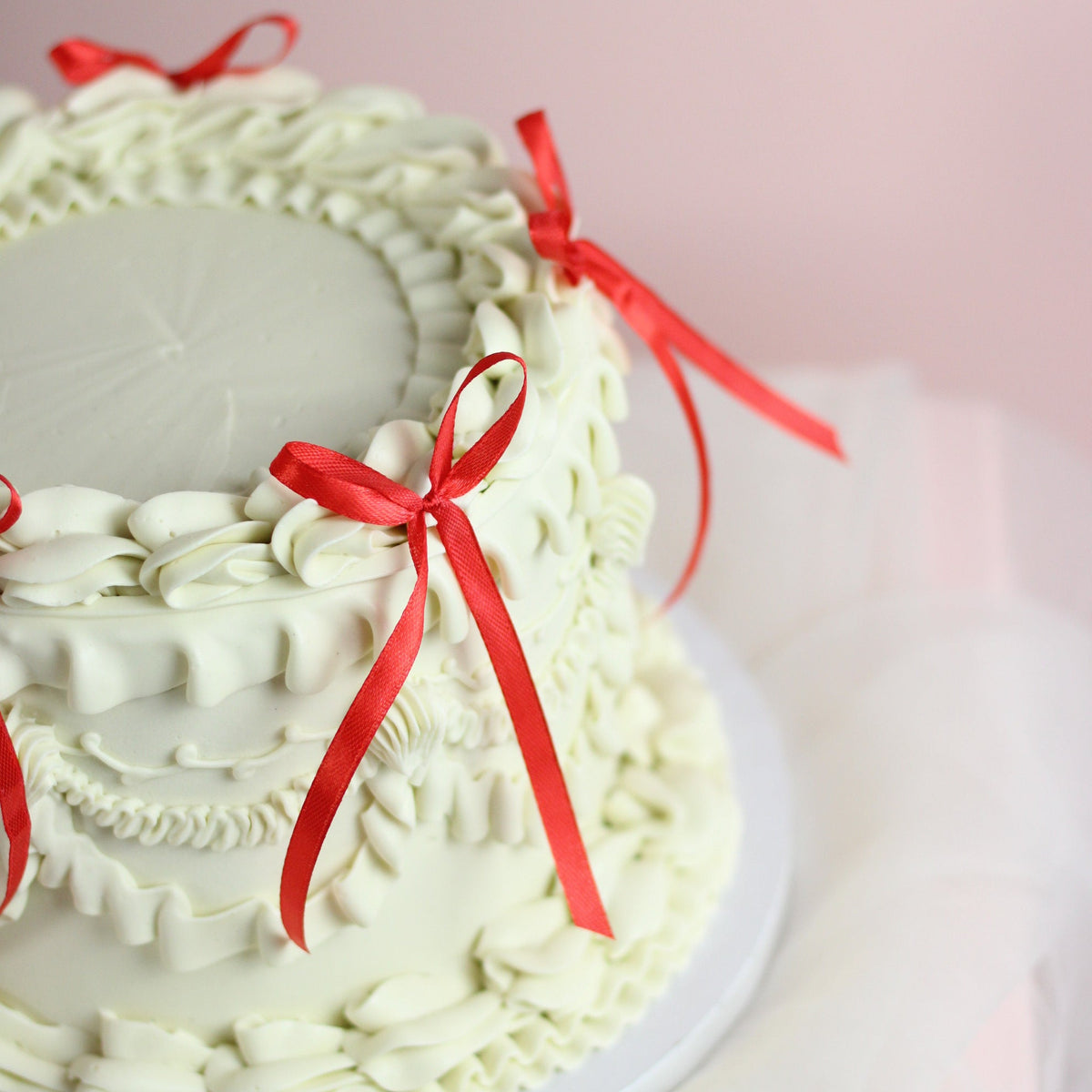 White vintage cake with red bows - festive and oh so cute!