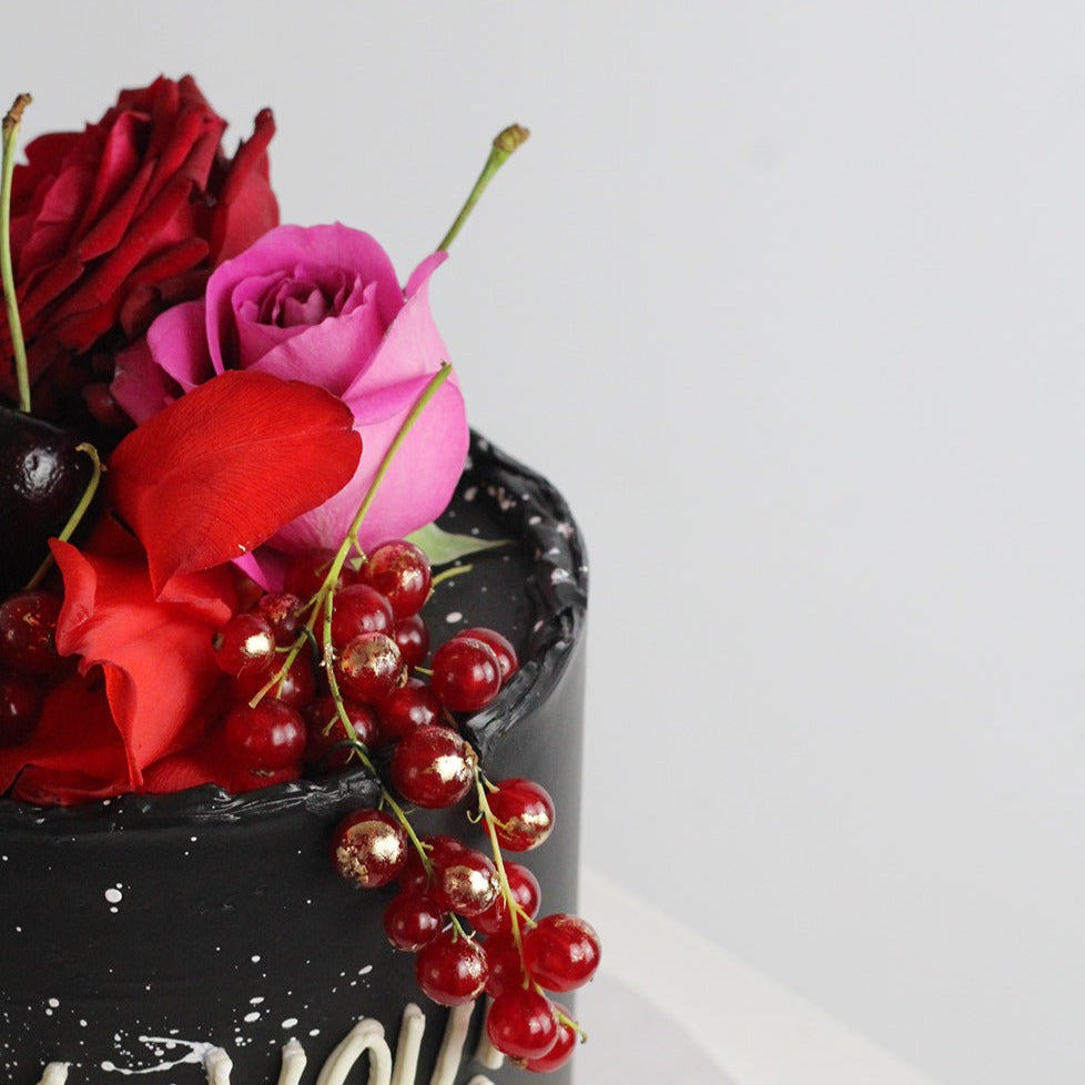 BOLD BEAUTY cake: decorated with bold poppy florals and fresh fruits, on a black cake base