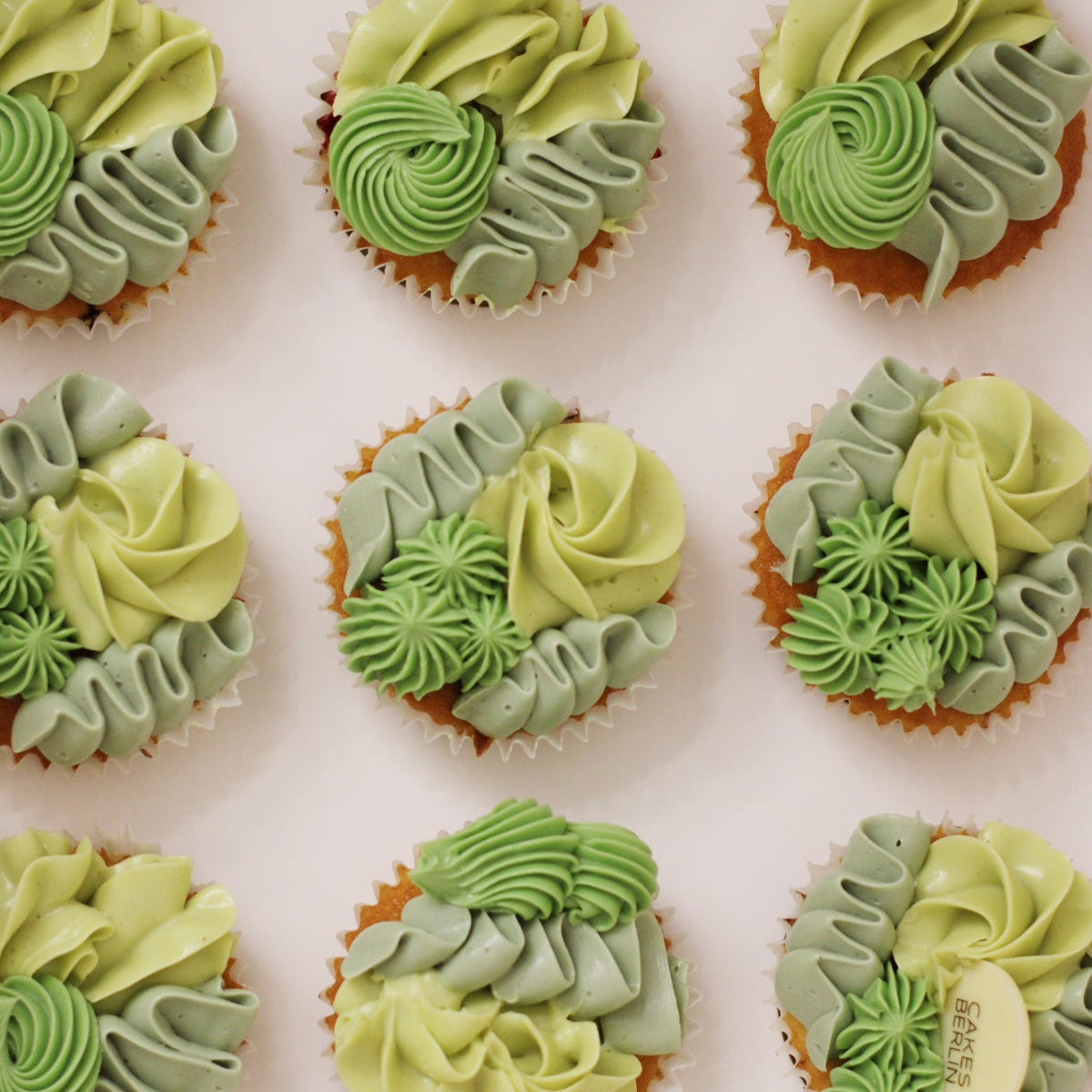 Mixed piping cupcakes in shades of green