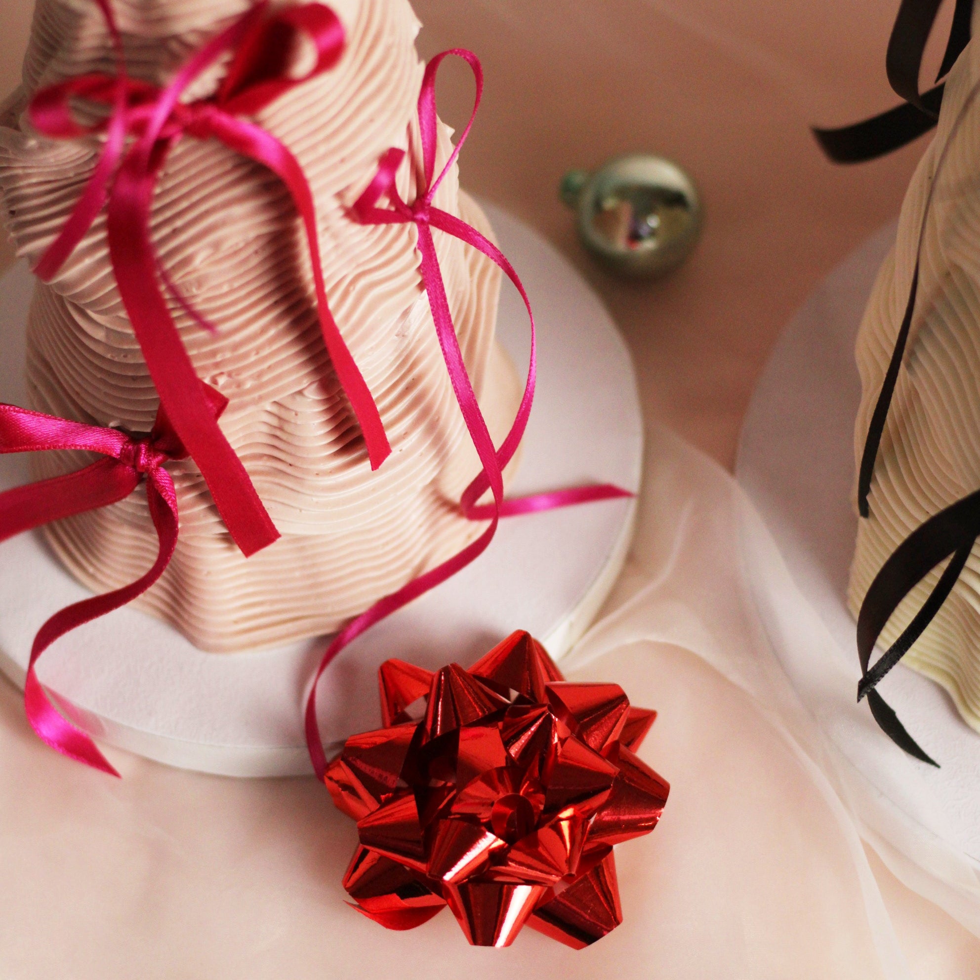 Festive tree-shaped buttercream cake decorated with elegant piping and silk bows - the perfect Christmas centerpiece.