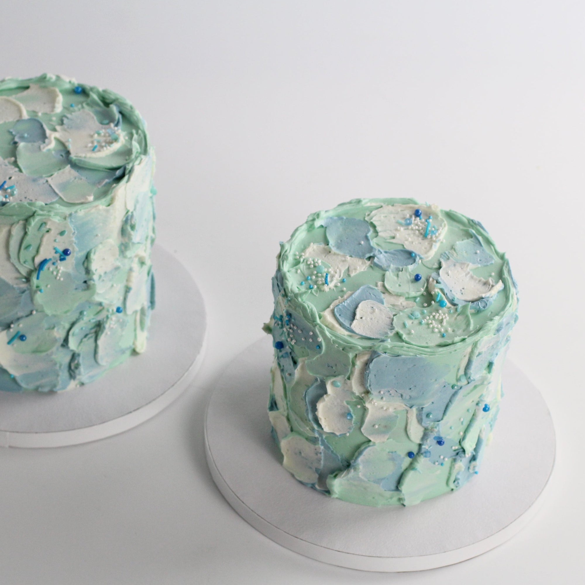 Our signature Birthday Cloud Cake with blue & mint fluffy icing and a dash of fun sprinkles.