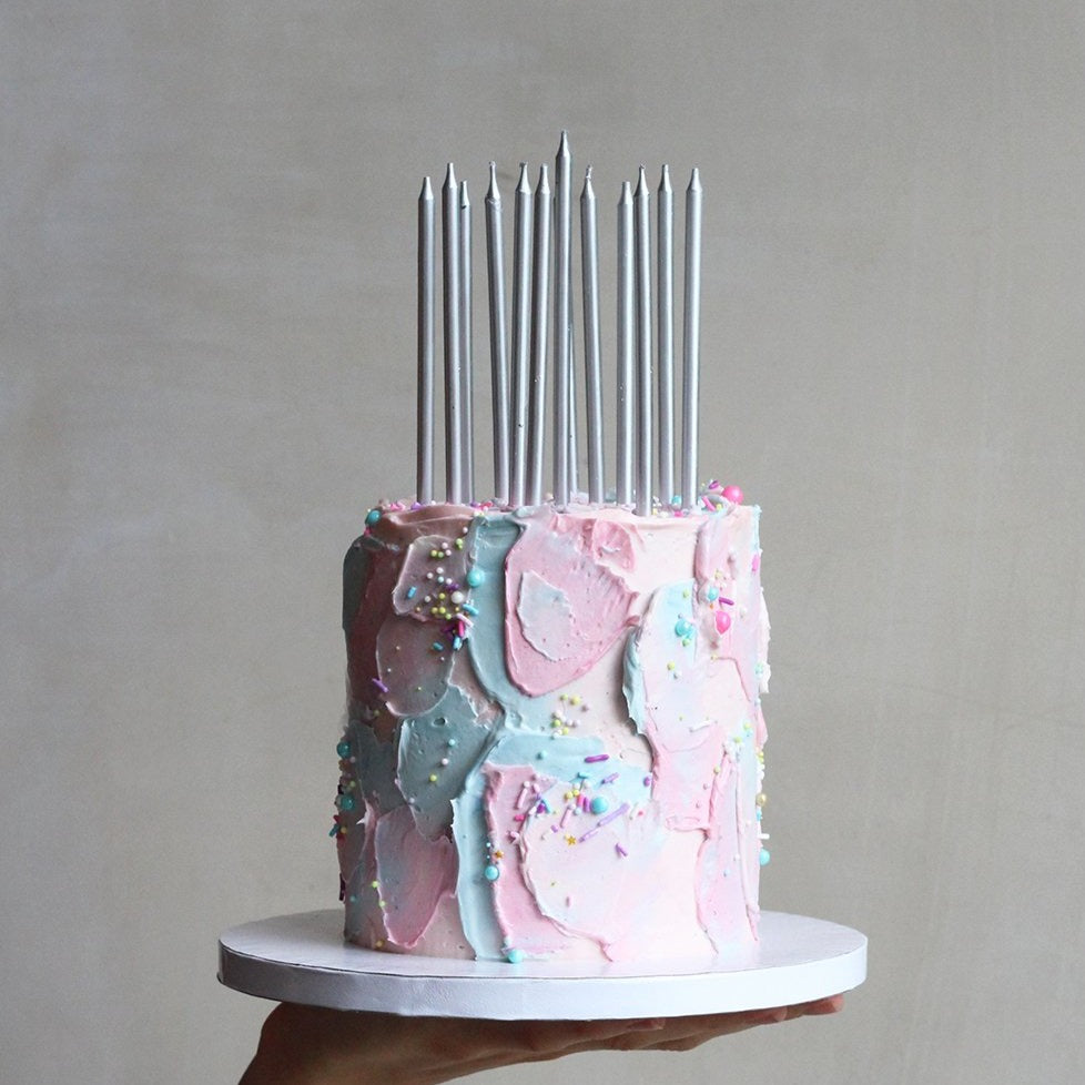 Our signature Cloud Cake with blue & pink fluffy icing and a dash of sprinkles.