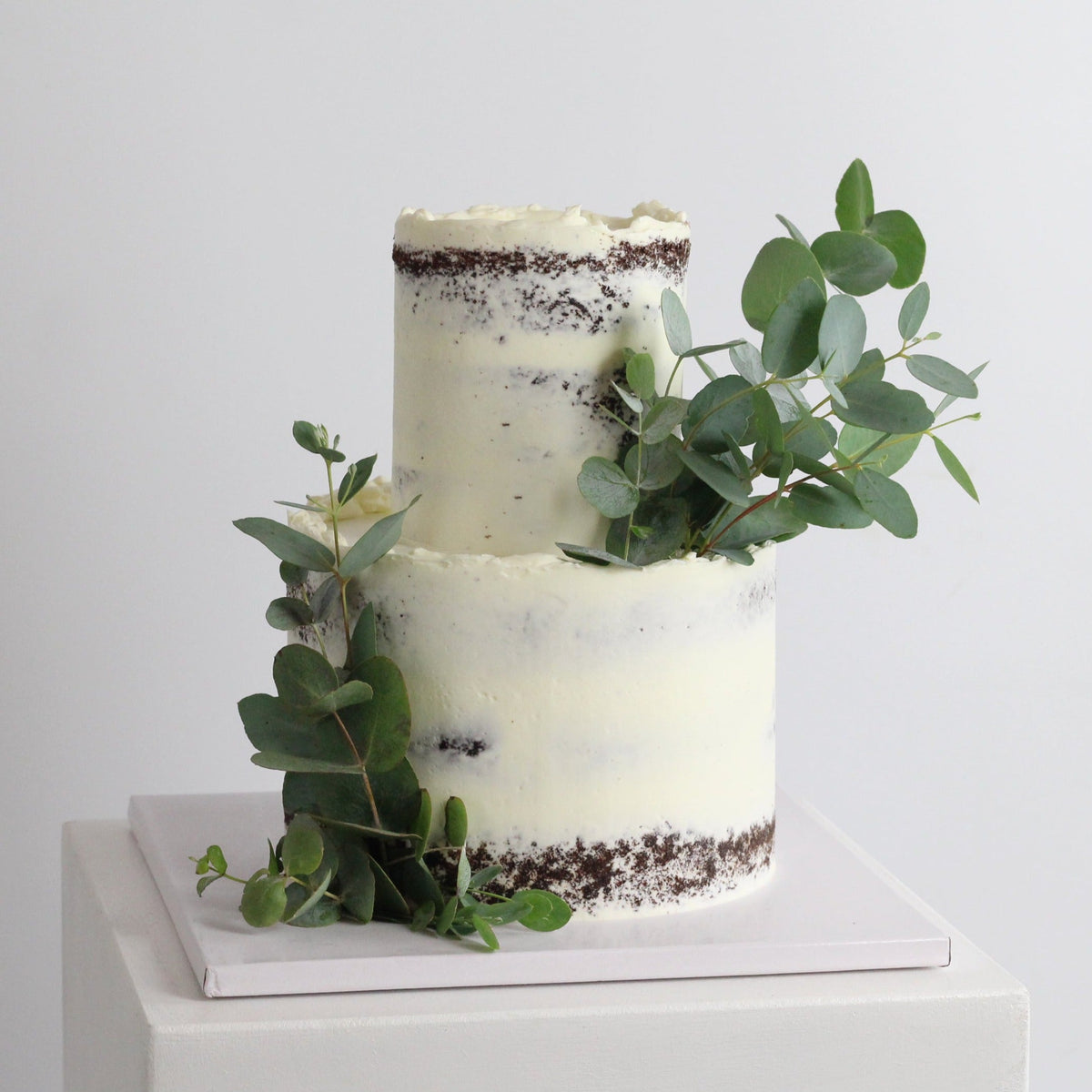Forest Fairy Cake - Our signature semi-naked style adorned with Eucalyptus &amp; your favorite greens!