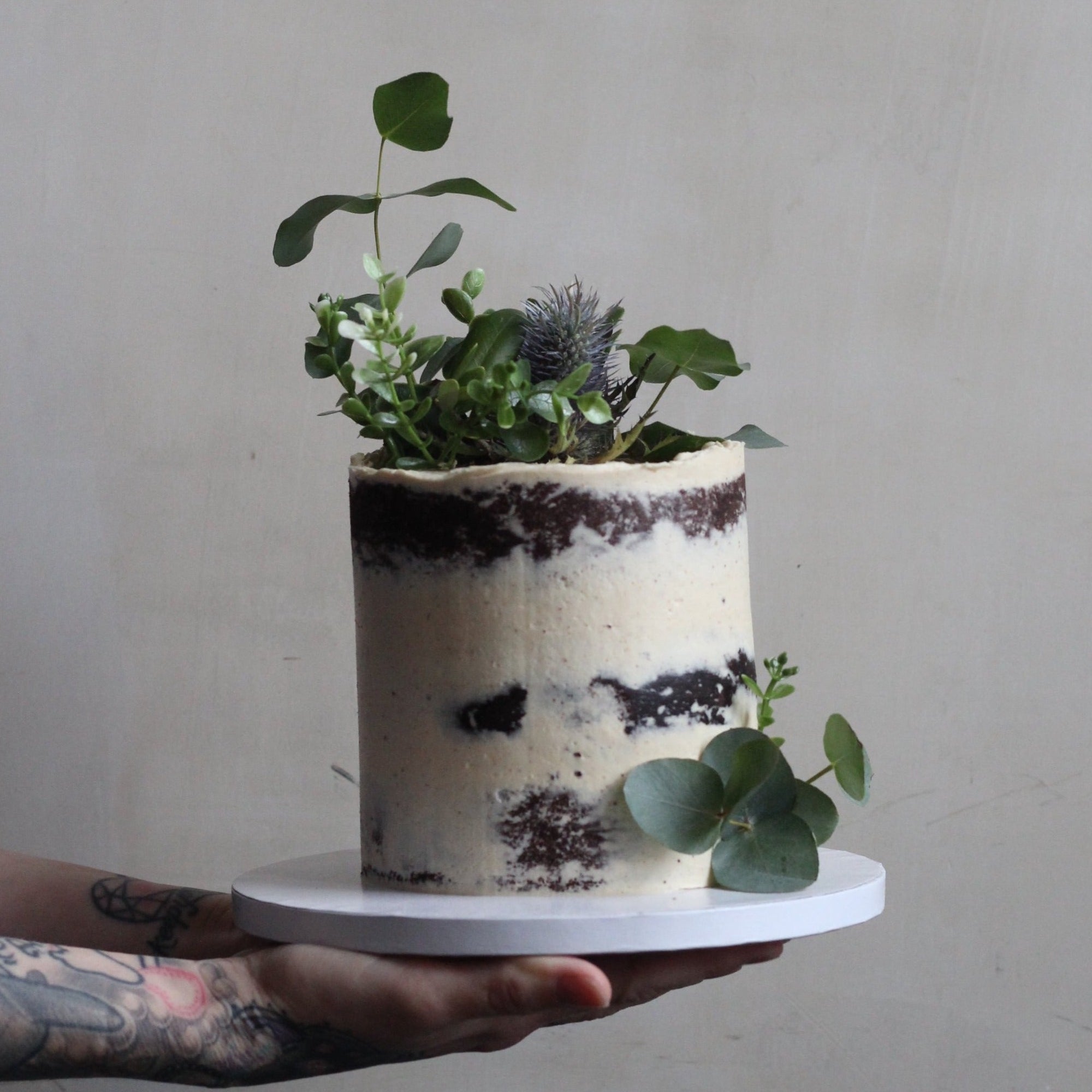 Forest Fairy Cake - Our signature semi-naked style decorated with Eucalyptus leaves. Made at our bakery in Kreuzberg - Delivered in Berlin.