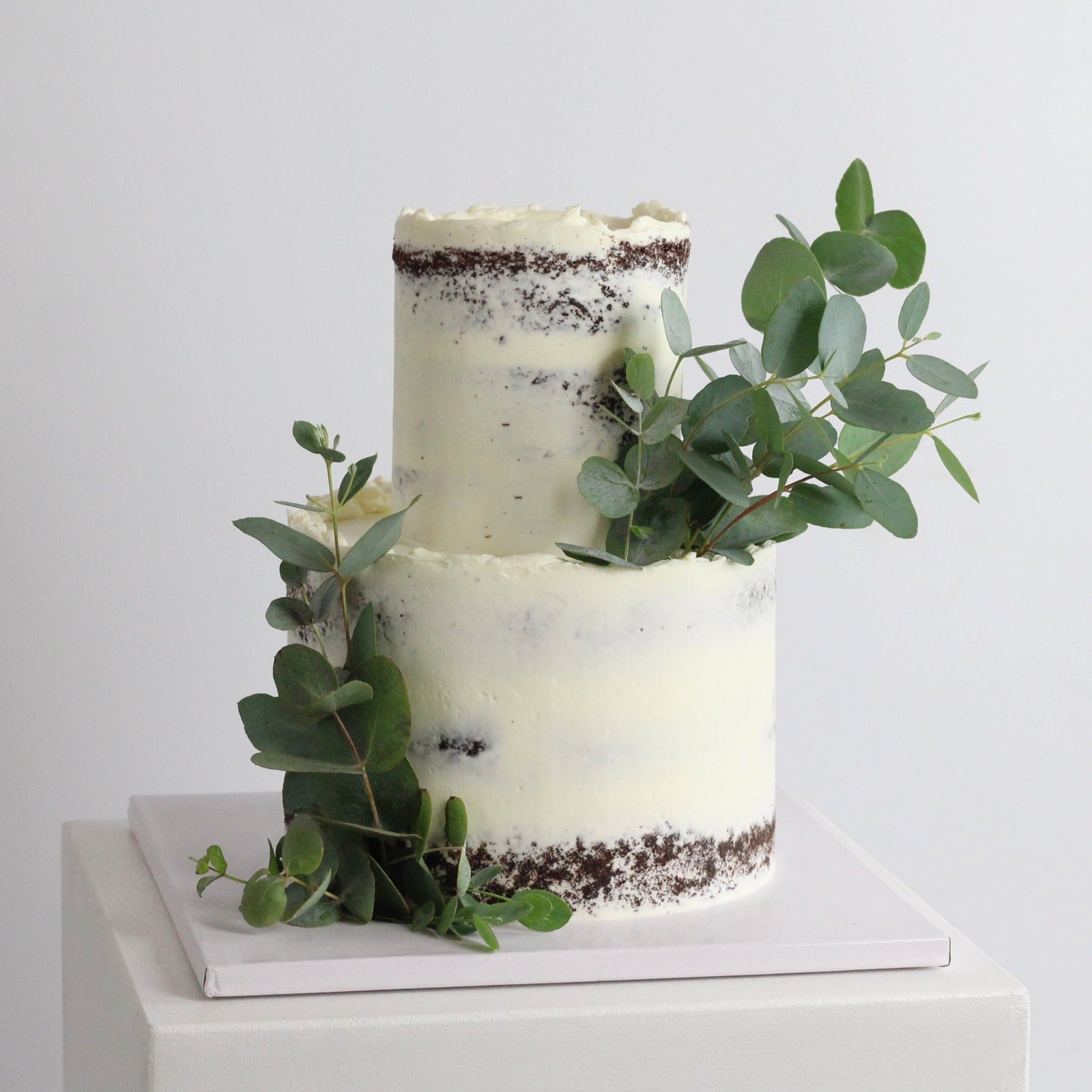 Forest Fairy Cake - Our signature semi-naked style cake, decorated with Eucalyptus. Made in Kreuzberg delivered in Berlin.