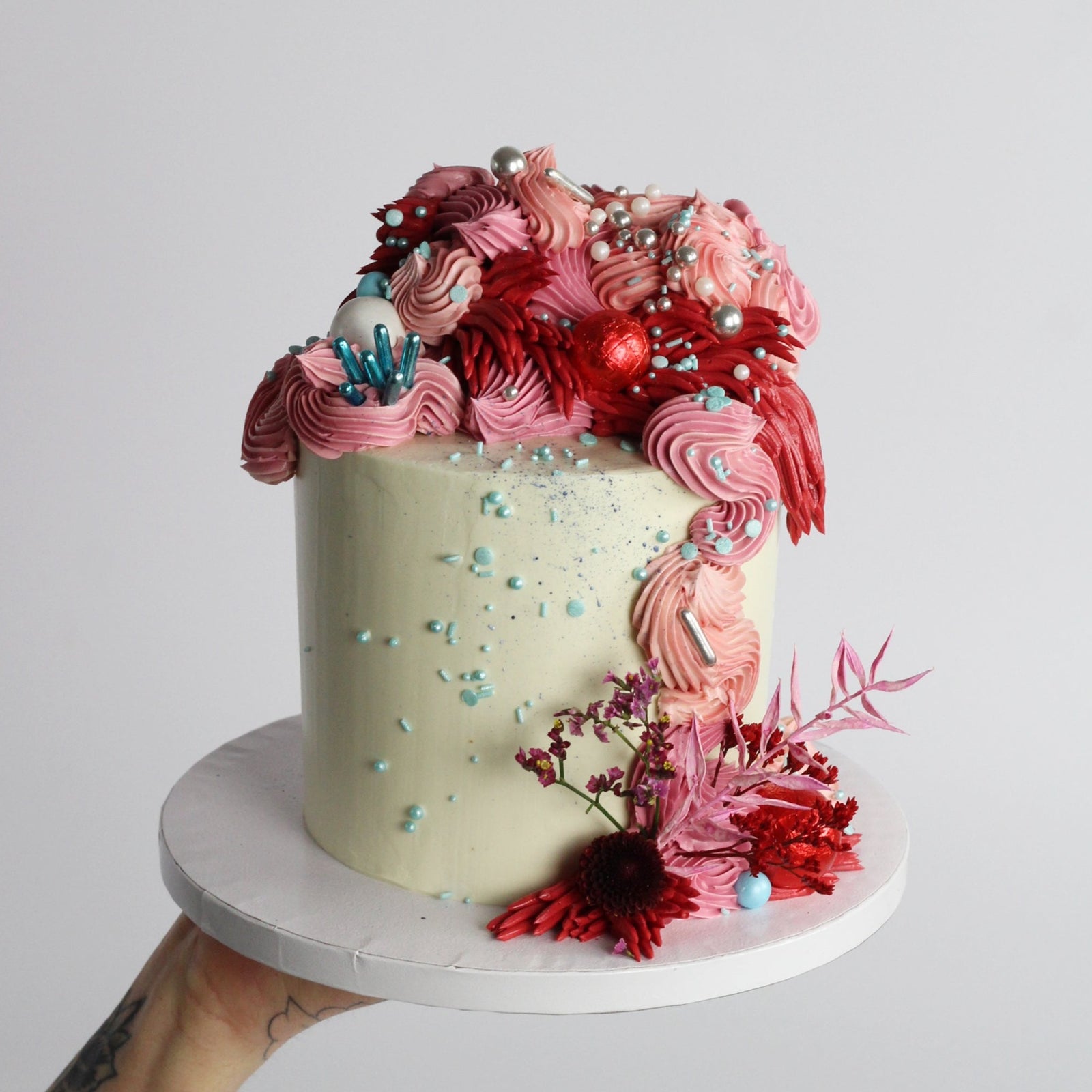 Our signature Shag Cake in red tones, covered in shaggy buttercream!