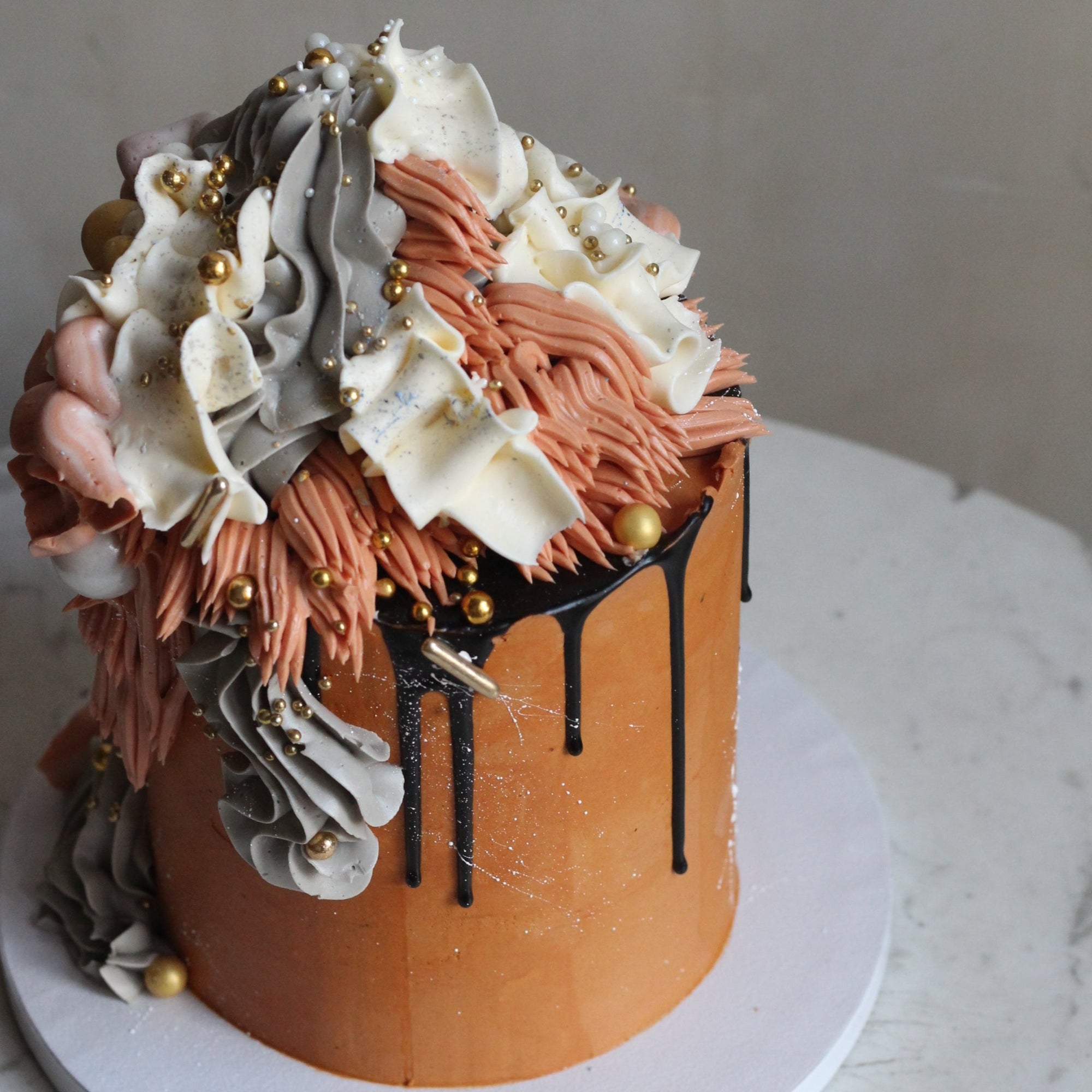 Our signature Shag Cake in warm tones, covered in shaggy buttercream!