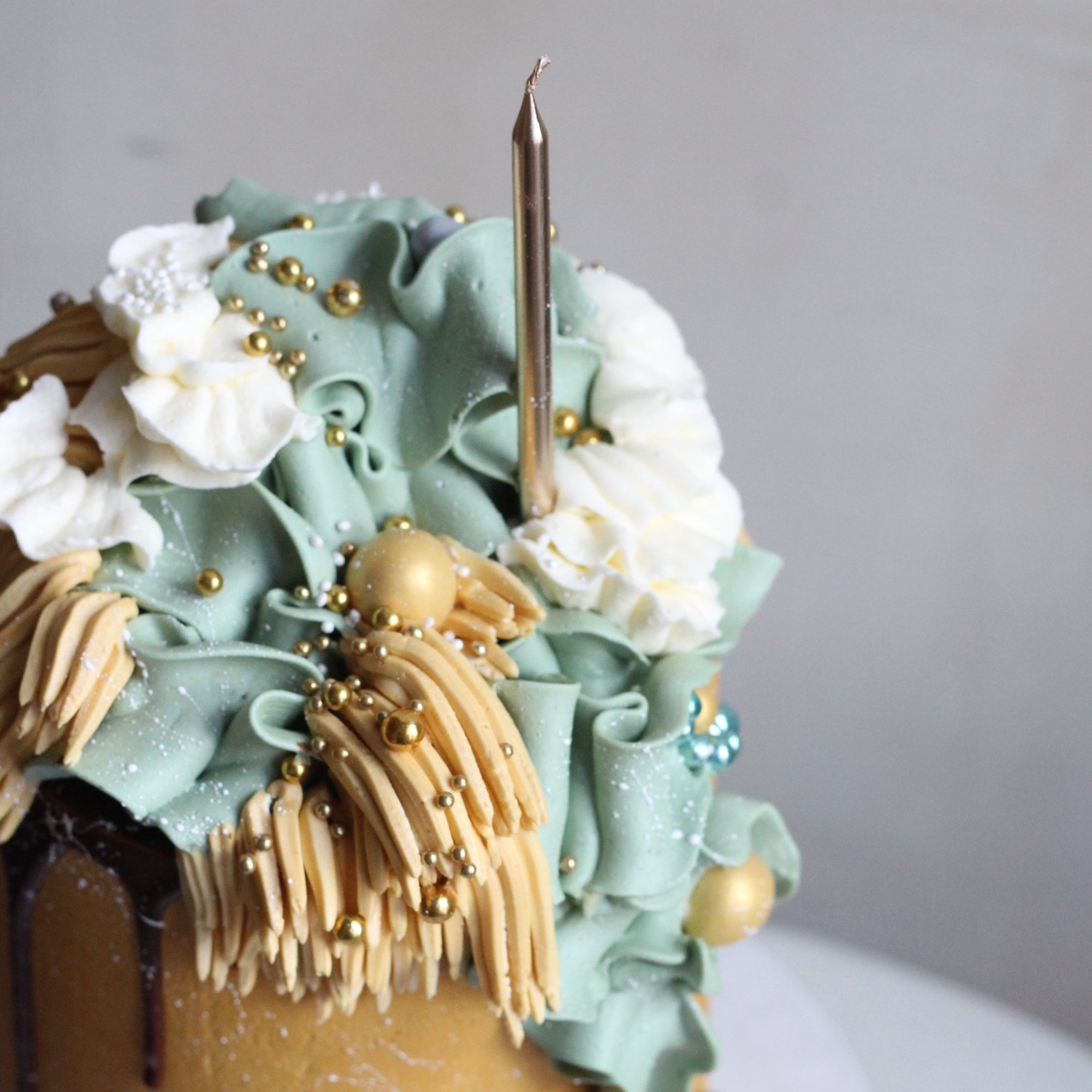 Our signature Shag Cake in warm tones, covered in shaggy buttercream!