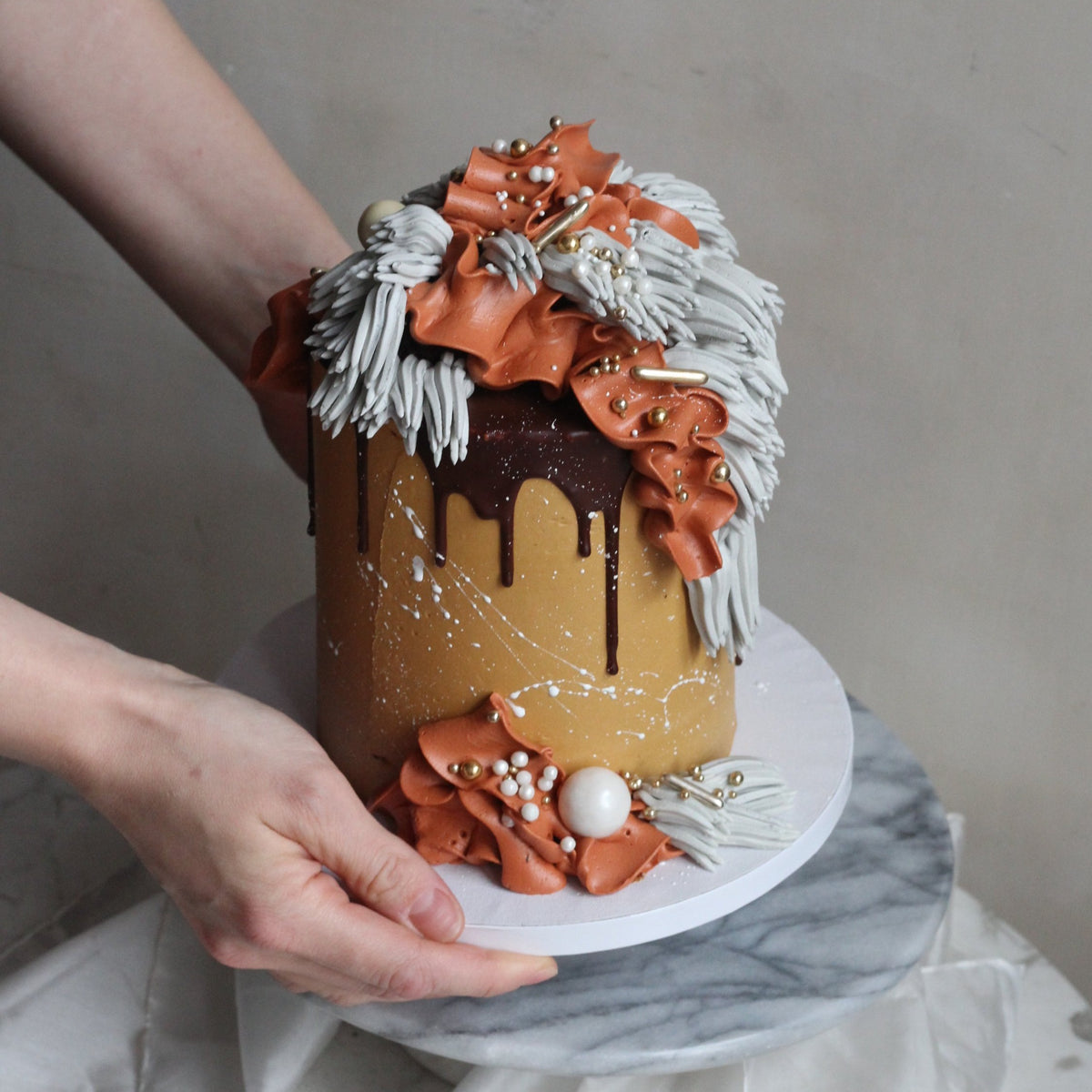 Our signature Shag Cake in warm tones, covered in shaggy buttercream!