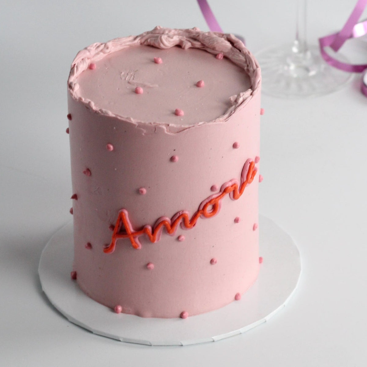 Celebrate love with our pink AMORE cake!