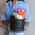 Blossom Hat Cake with black icing, metallic splashes & a funky bold headpiece of fresh flowers.