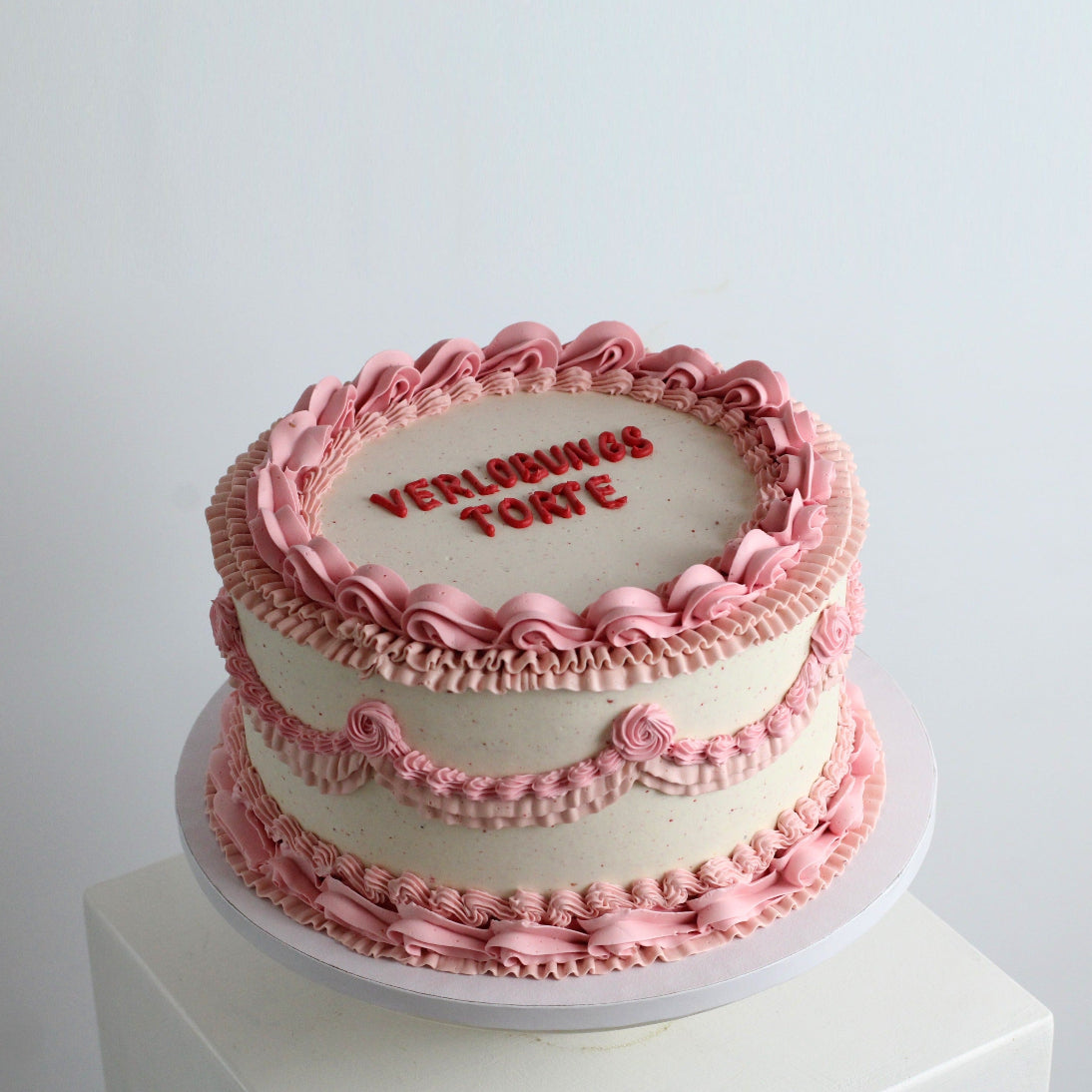 Pink vintage style engagment with red writing - chocolate & peanut buttercream inside!
