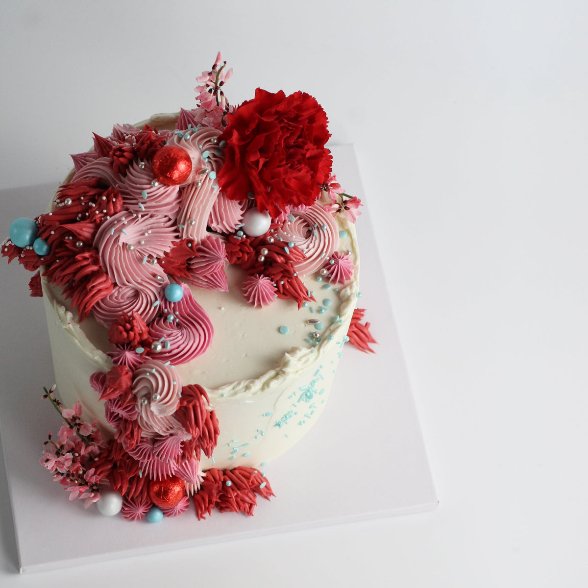 Our signature Shag Cake in red tones, covered in shaggy buttercream!