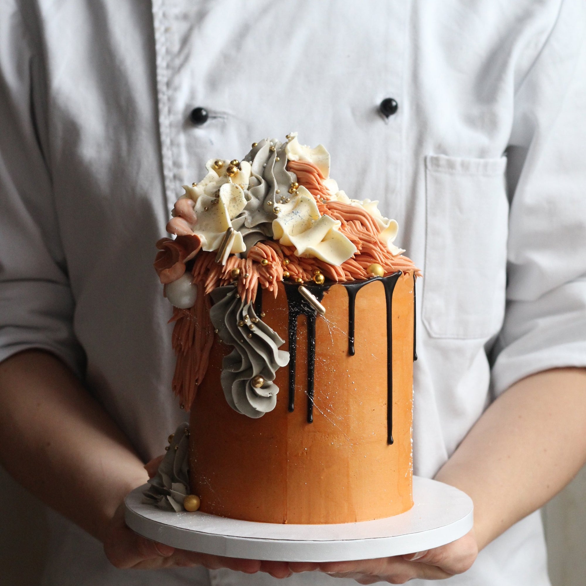 Our signature Shag Cake in warm tones, covered in shaggy buttercream!