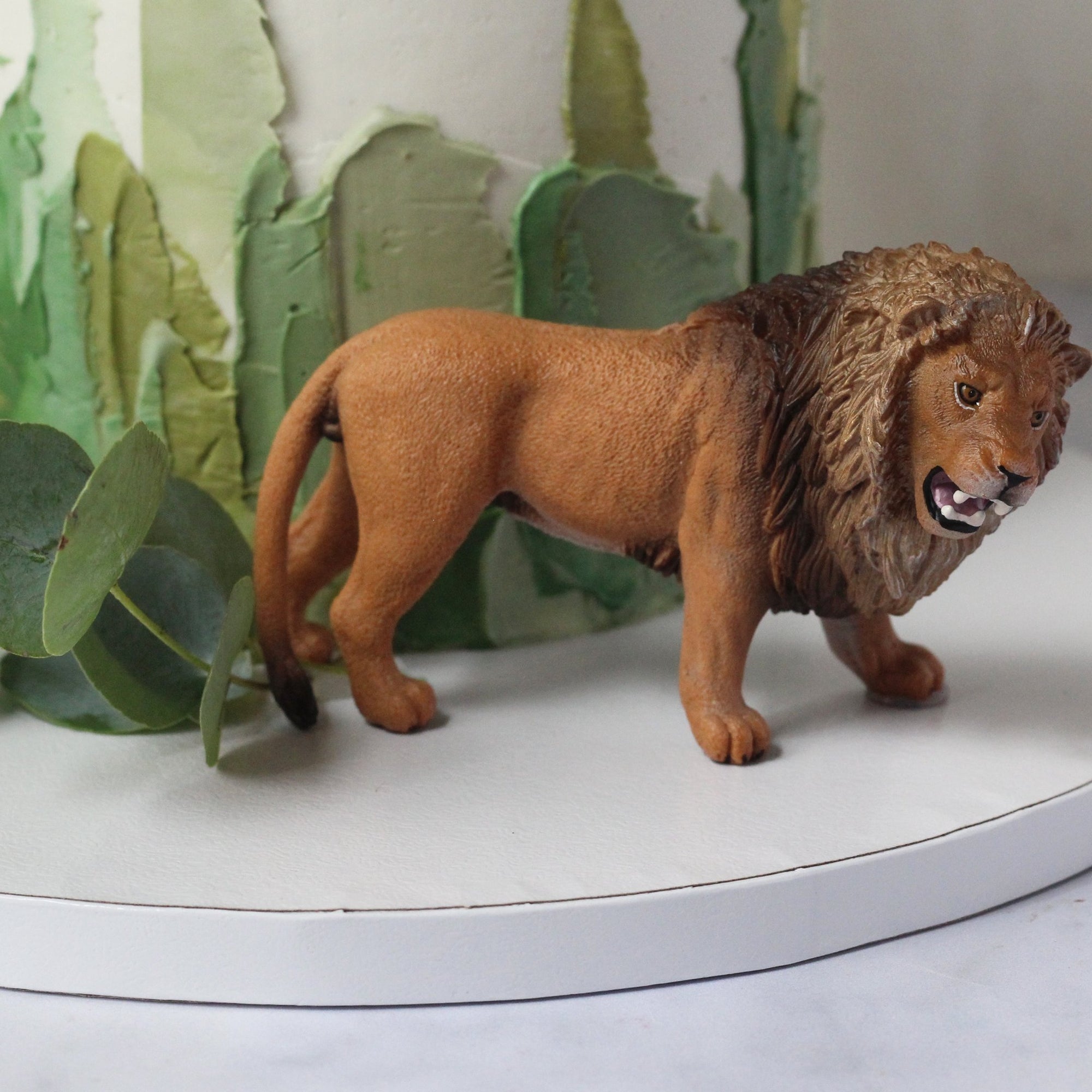 The Safari Tour Cake - perfect for those who want to get away! Adorned with brushstrokes, leaves and a figurine.