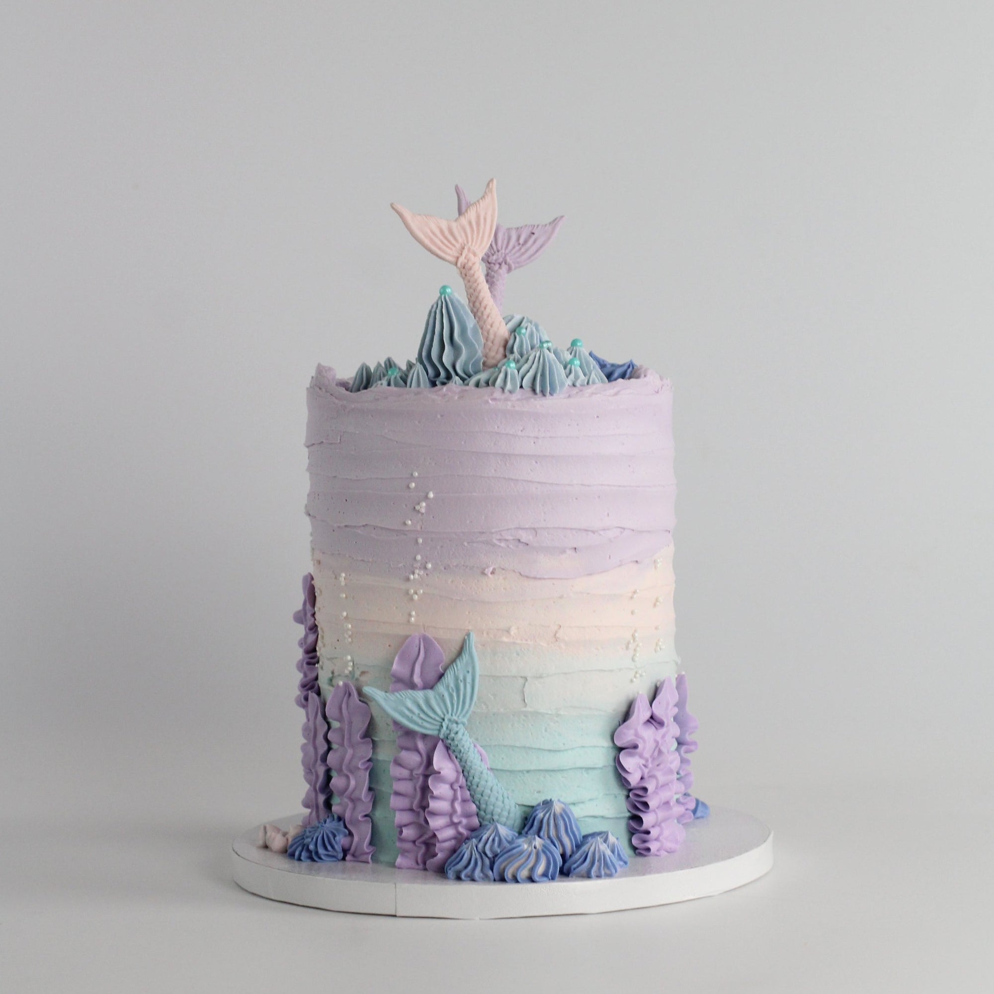 Mermaid underwater cake - decoated with sugar nermaid tails, buttercream reef & and pearls