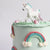 Our Rainbow Cake with peach & mint ombre icing, 3D rainbows, creamy ruffles & unicorn topper!